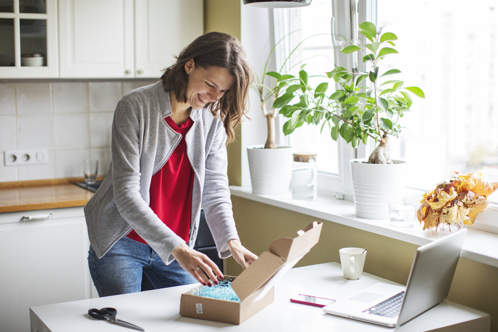 Woman buying through a website online and receiving package
